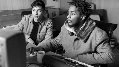 image of two young people sitting next to each other in a recording studio