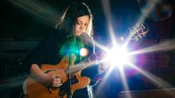 young person playing guitar