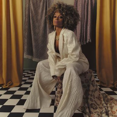 fleur east poses in a cream sequin suit