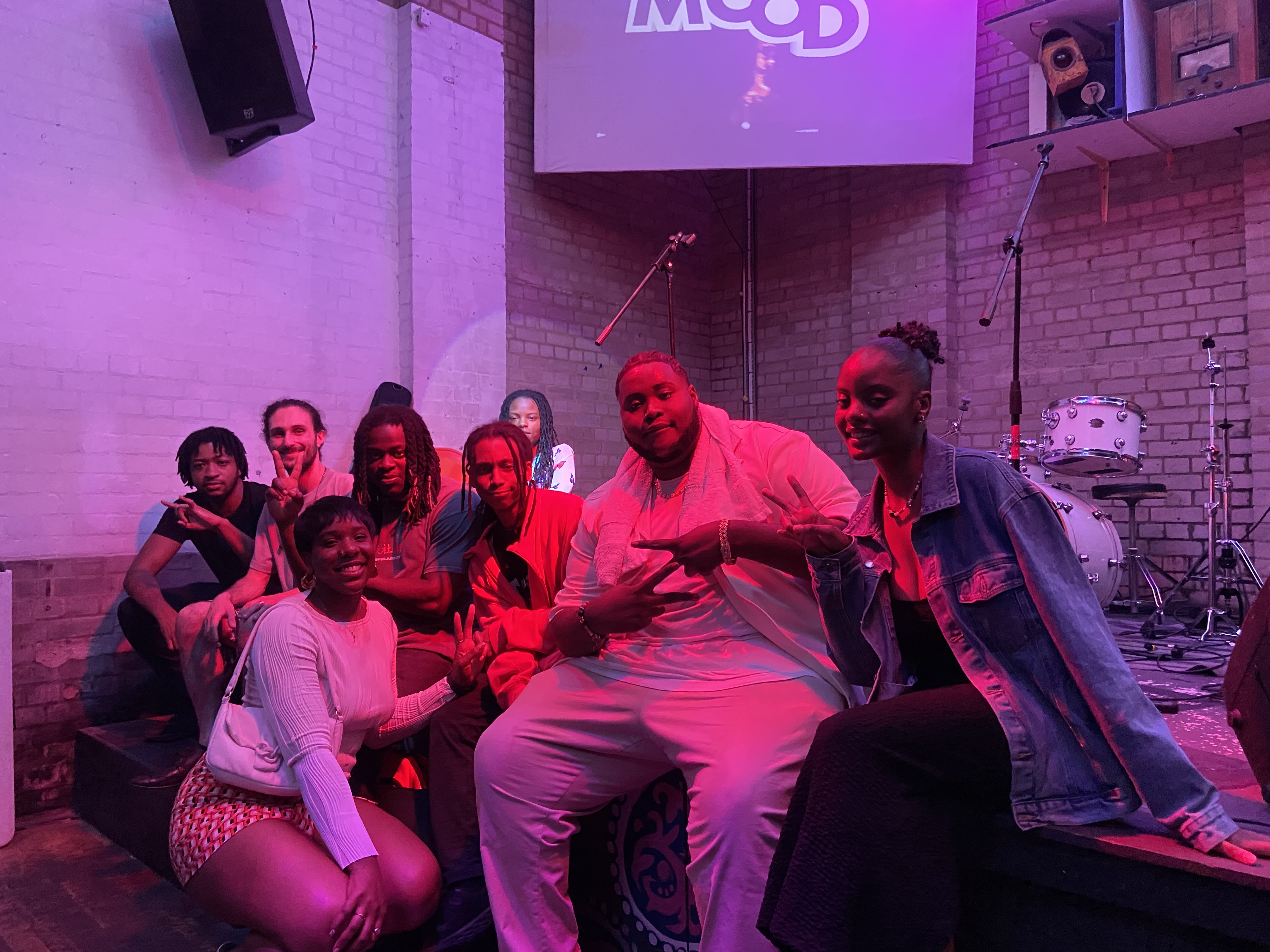 a group of people sit on a sofa and pose together