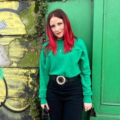 kelly betts wears a green jumper