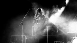 black and white photo of young man on stage 