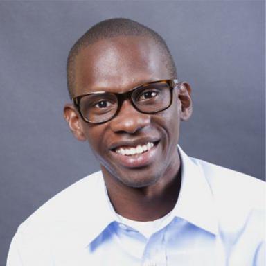 headshot of a man wearing a white shirt and glasses