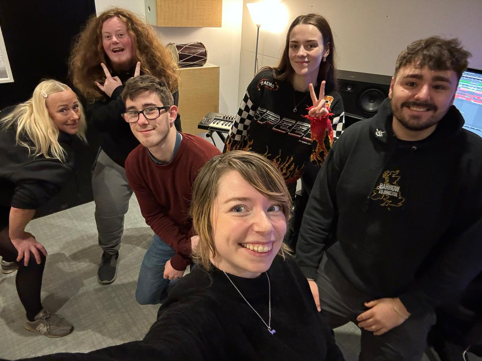 a group of people pose for a selfie and smile