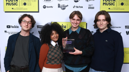 english teacher stand together and hold their award