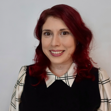 a woman with red hair smiles