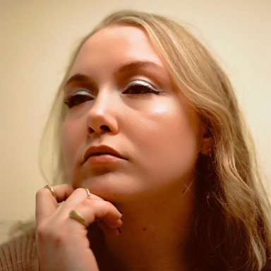 a woman with blonde hair wears silver eyeshadow